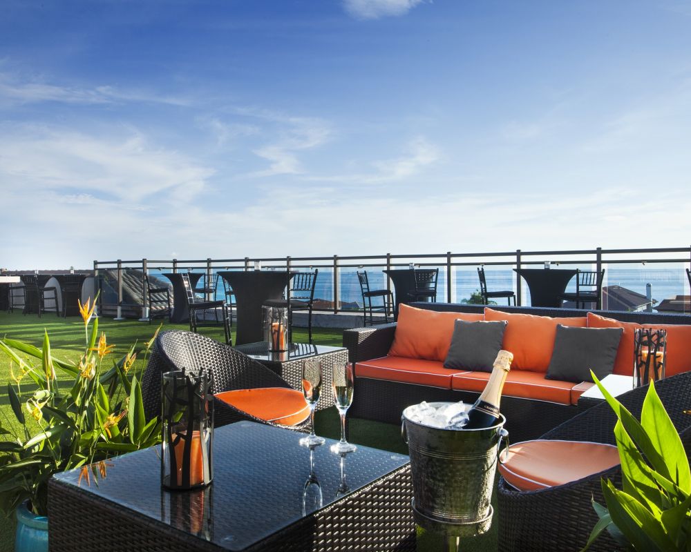 lounge seating with champagne glasses on 360 rooftop