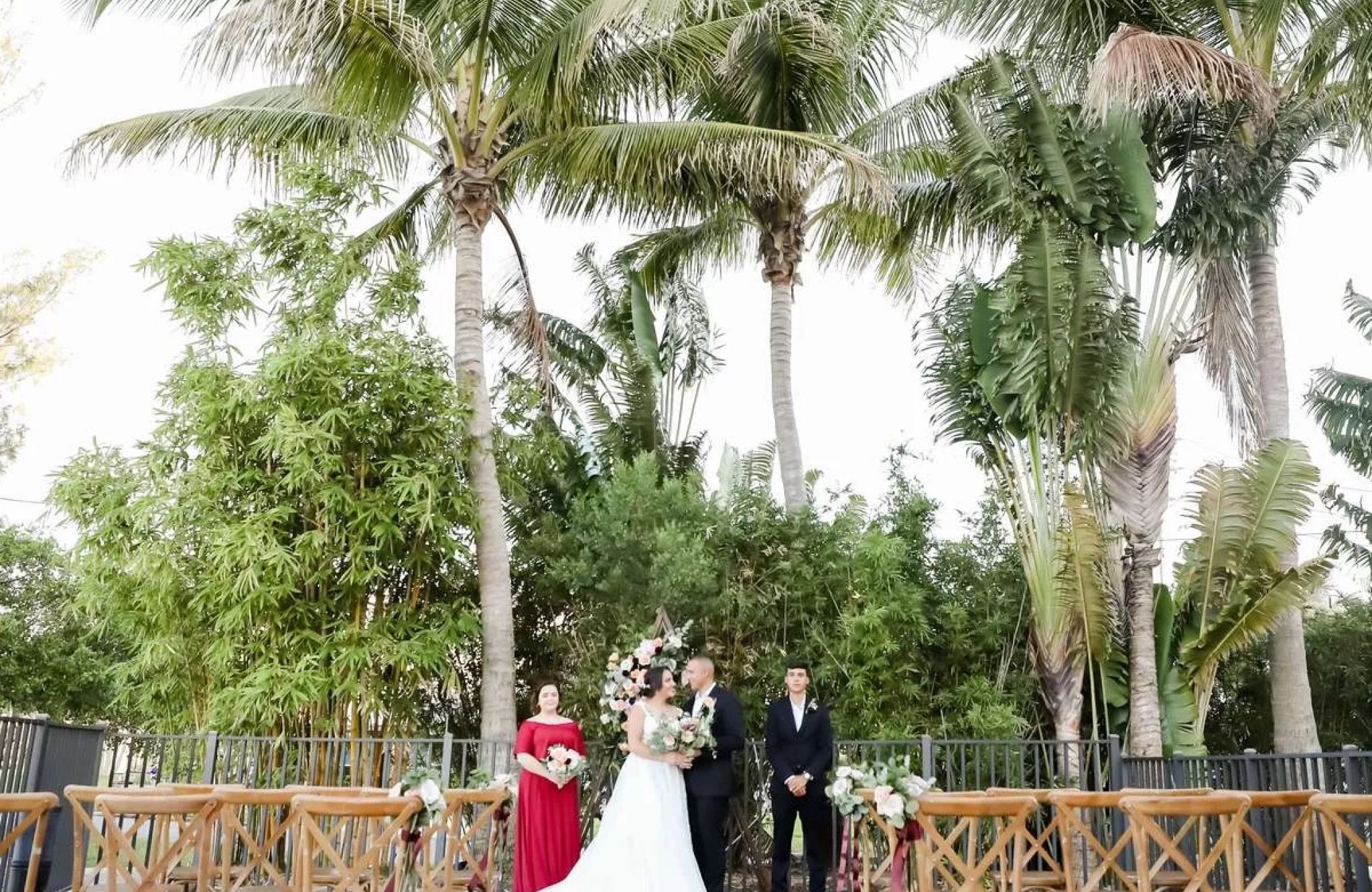 Outdoor wedding or event space with chairs and tropical plants all around